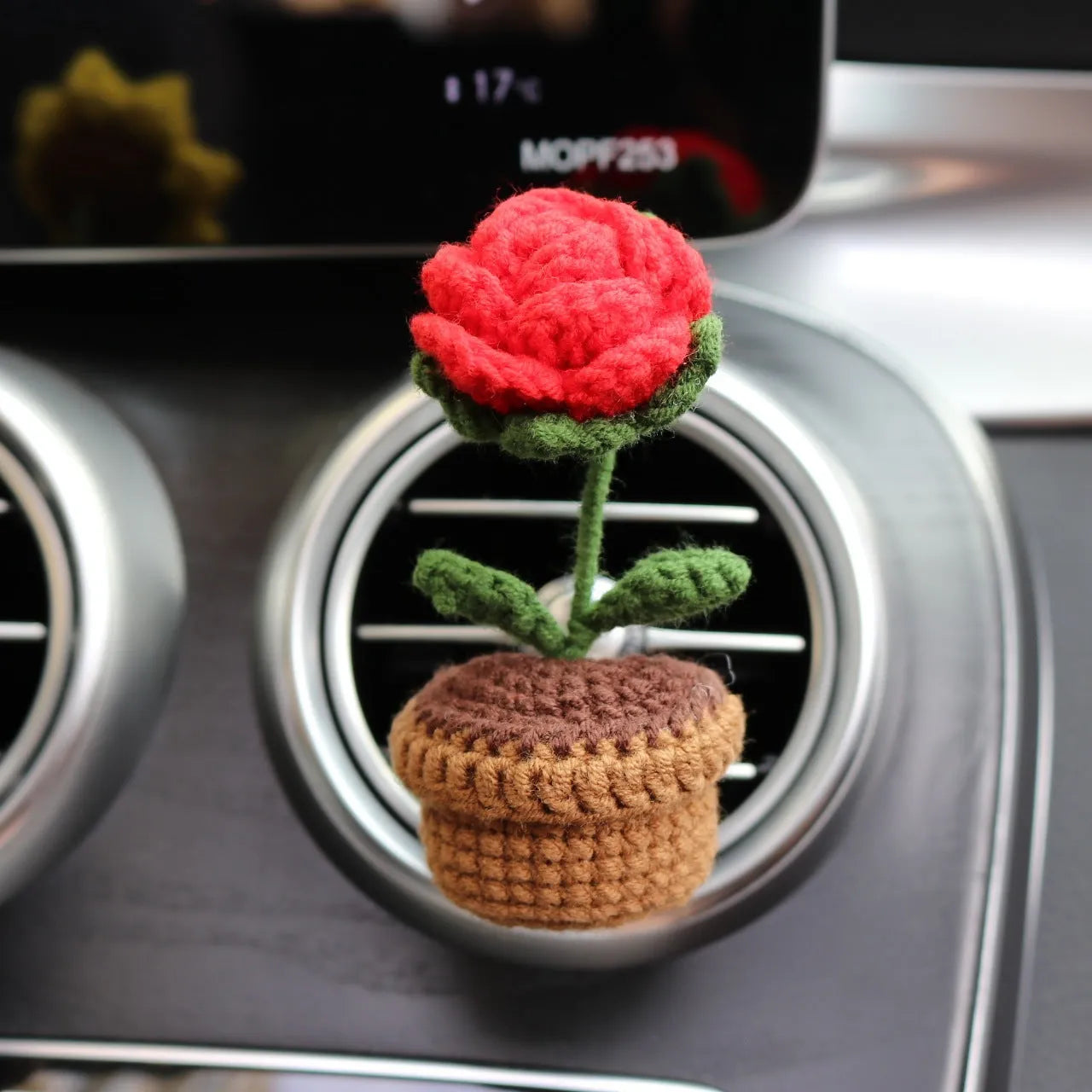 Creative wool potted plant car air vent clip aromatherapy pendant on a car vent.