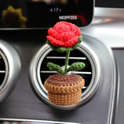 Creative wool potted plant car air vent clip aromatherapy pendant on a car vent.