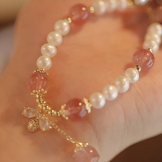Women's adjustable Strawberry Quartz crystal bracelet with bow charm on wrist