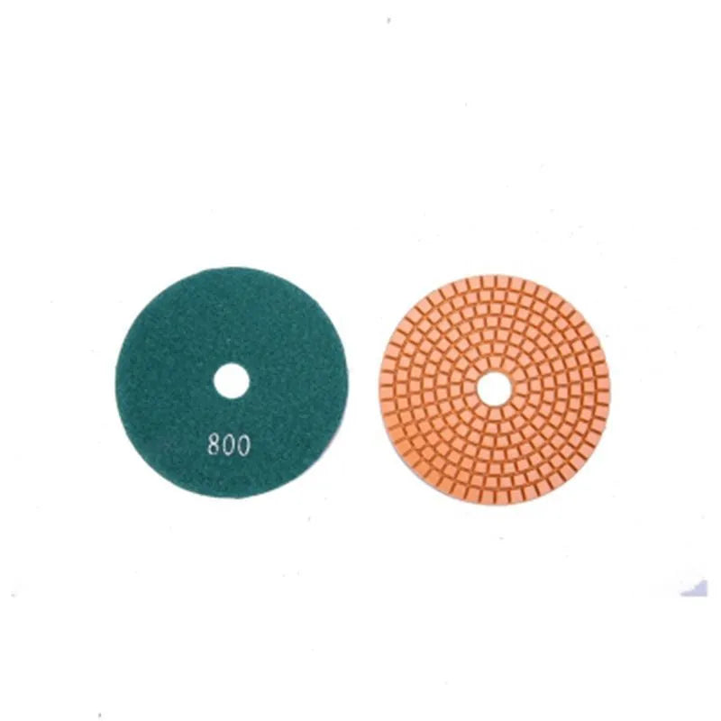 Set of 10 circular stone polishing pads with emery abrasive on a white background.