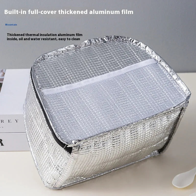 Insulated lunch box bag in sapphire blue textured cloth, shown with a lunch box inside.
