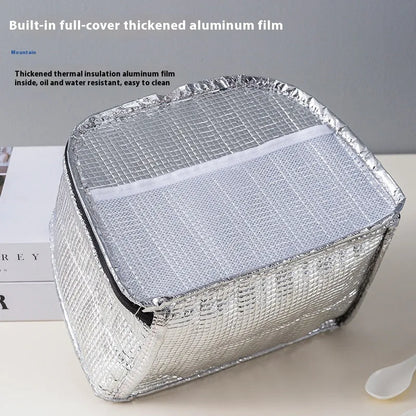 Insulated lunch box bag in sapphire blue textured cloth, shown with a lunch box inside.