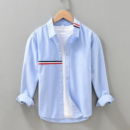 Hong Kong style loose cotton blend cardigan shirt in light blue on a hanger
