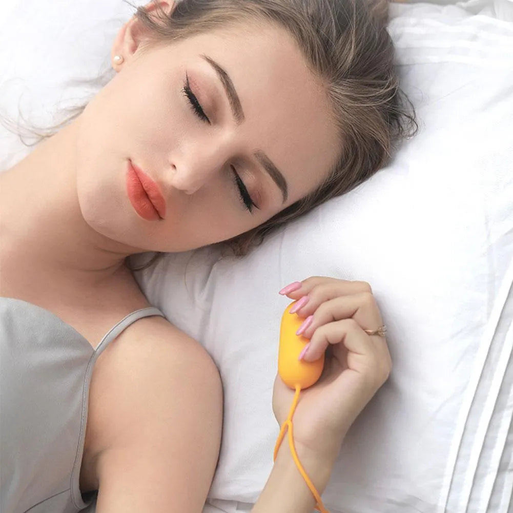 Hand-held micro-current sleep aid device in grey, green, and orange colour options