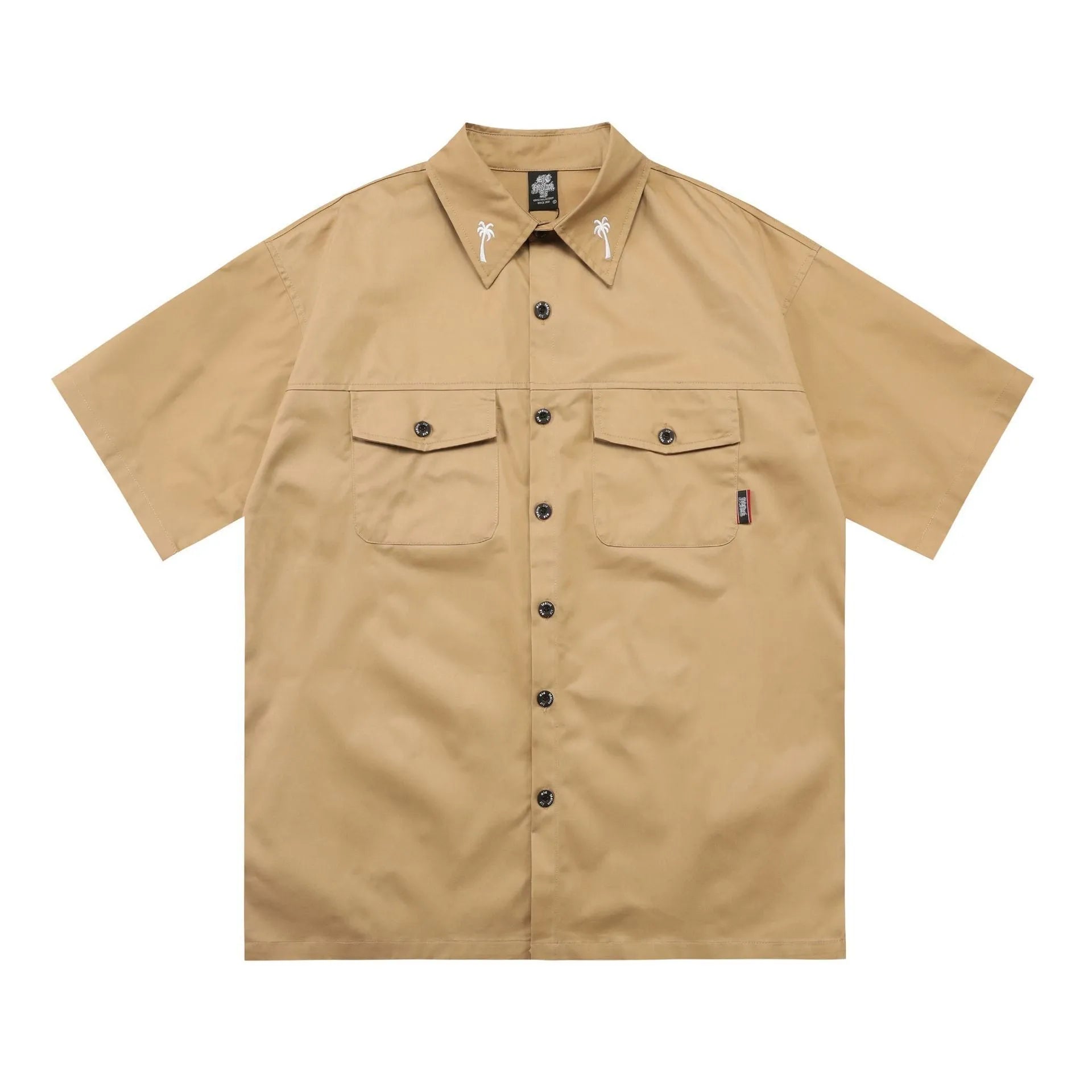 Man wearing a black cotton blend half-sleeve loose fit work shirt with embroidered detail.