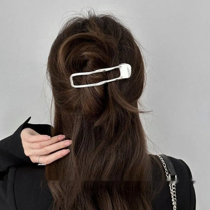 Women's gold and silver zinc alloy hair barrettes in arc, square, and triangle shapes.