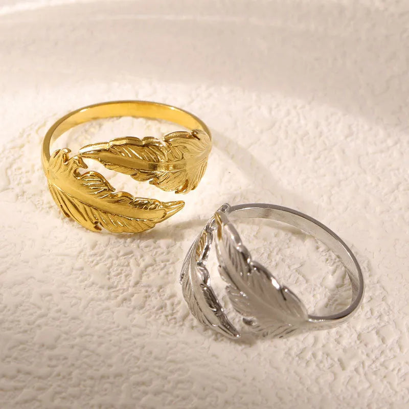 Women's fashion feather ring made from stainless steel with adjustable opening size and electroplated finish available in gold and silver colour options for everyday wear and style versatility