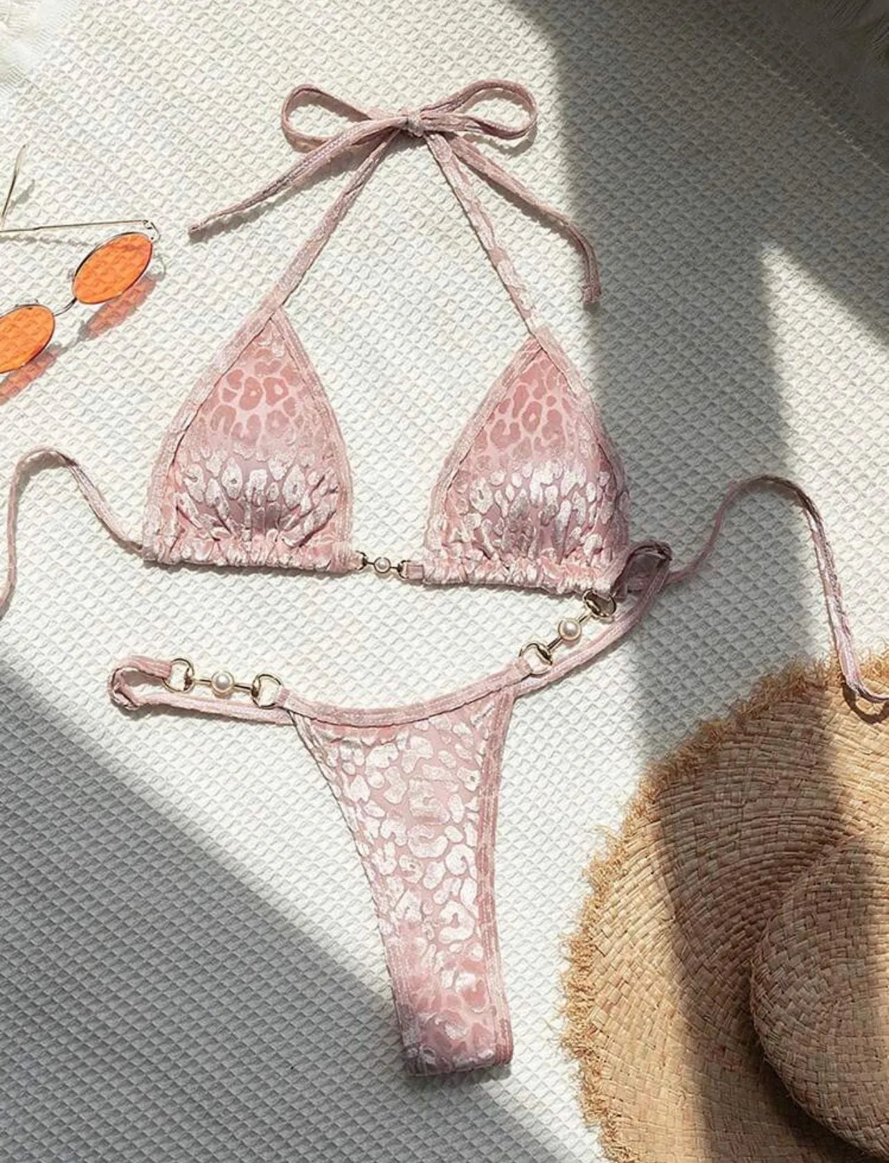 Women's blue leopard print T-shaped bikini set for swimming on a mannequin.