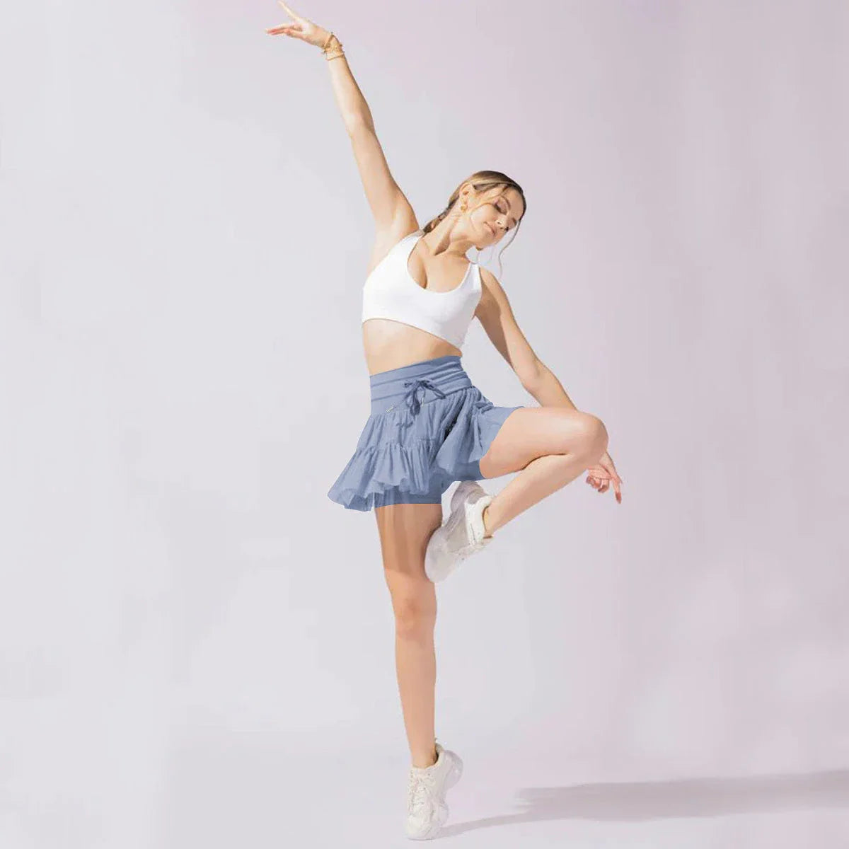 Stylish high-waist pleated mini skirt with lace-up design and built-in anti-exposure safety shorts, available in a variety of vibrant colors.