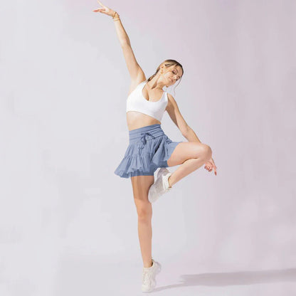 Stylish high-waist pleated mini skirt with lace-up design and built-in anti-exposure safety shorts, available in a variety of vibrant colors.