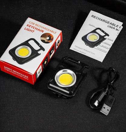 Black portable LED torch showing magnet, bottle opener, and multiple light modes with 500lm brightness