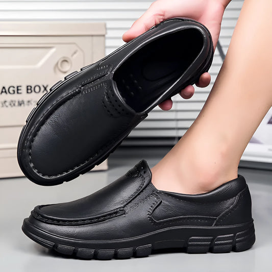 Men's black and brown slip-on work shoes with a mid-top, platform heel, and round toe.
