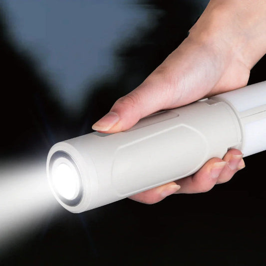 Folding LED camping lamp in ivory white with Type-C charging port and compact storage design