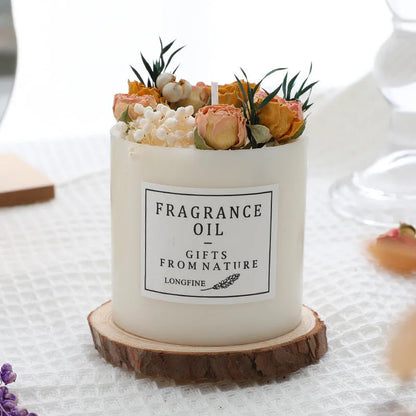 Aromatherapy candle with dried flowers decoration on a wooden chip base.
