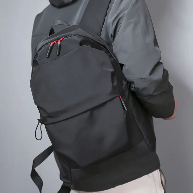 Sleek and durable nylon backpack with spacious compartments for everyday use.