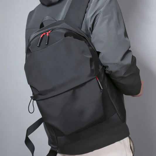 Sleek and durable nylon backpack with spacious compartments for everyday use.