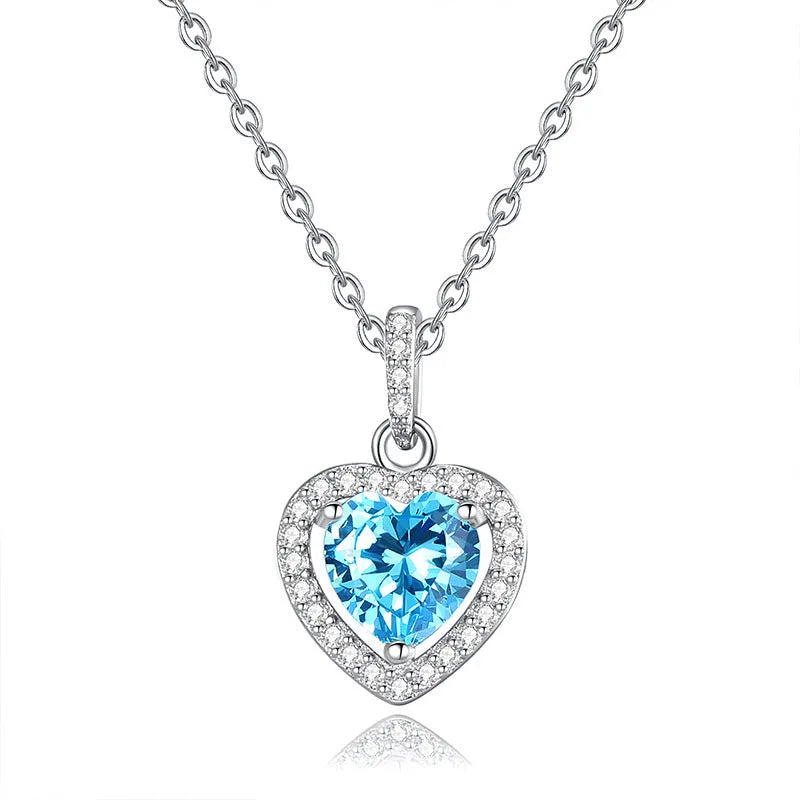 Sterling silver heart pendant necklace with a coloured gemstone on an adjustable chain.