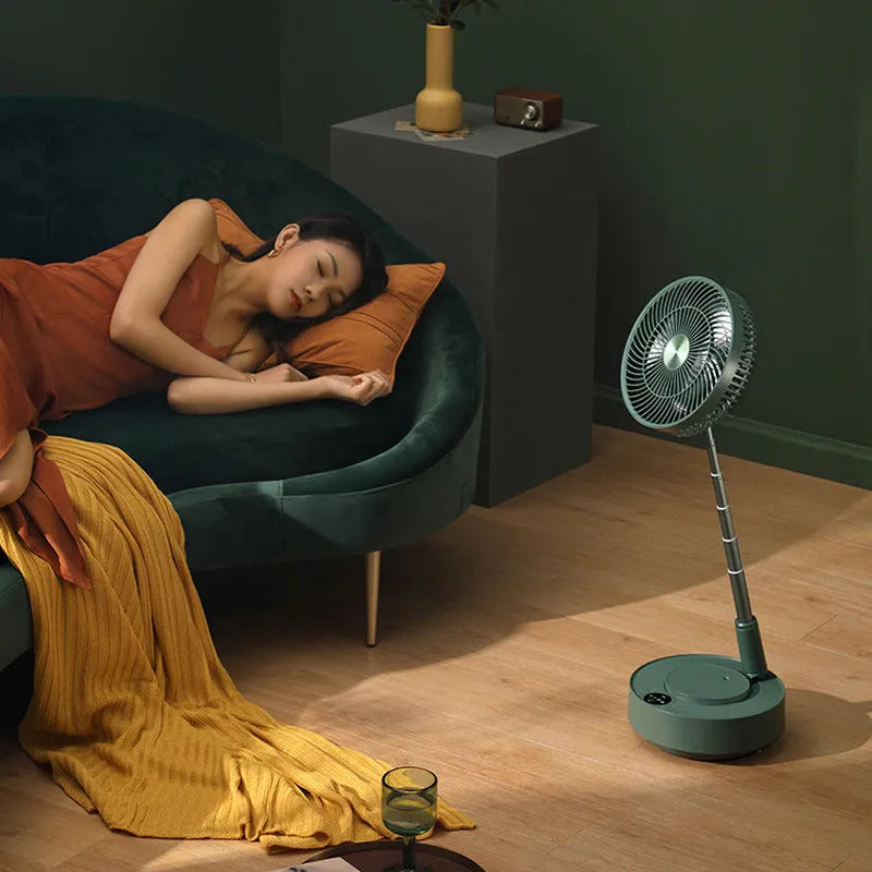 Green and white storage floor electric fan extended to vertical position with remote control