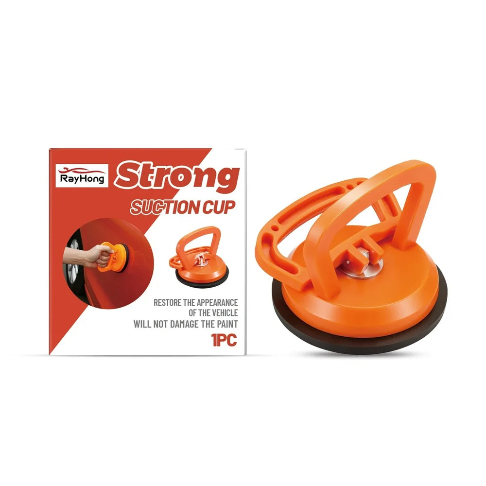 White plastic suction cup with metal pull tab on glass surface