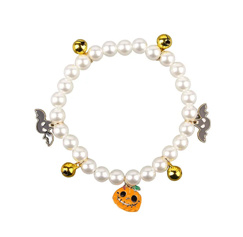 Halloween cat collar with simulated pearls and pumpkin-shaped charms in purple ghost, skull, and smiling designs.