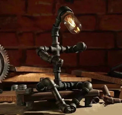 Vintage industrial iron pipe table lamp with soft, warm lighting and a green bronze finish