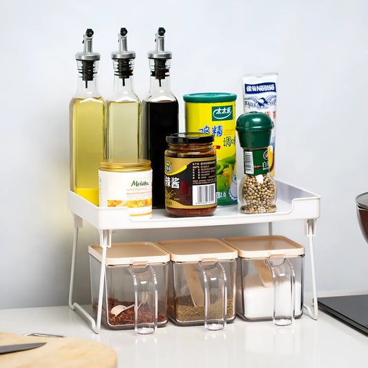 Transparent and white plastic kitchen supplies rack with multiple compartments for drawer and shelf organisation