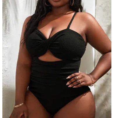 Black solid colour plus size one-piece swimsuit for women on a hanger.