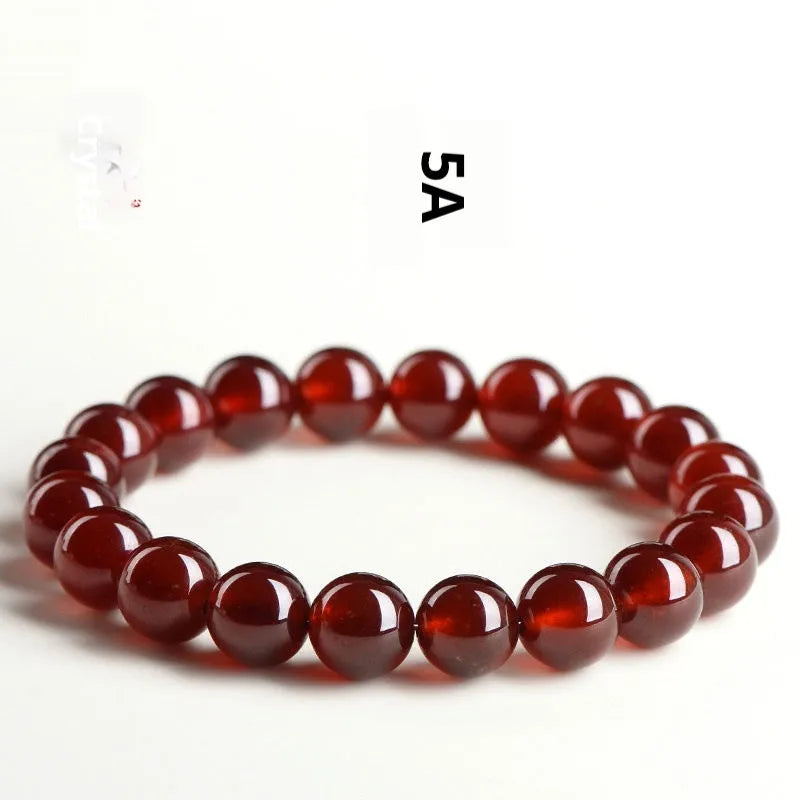 Natural orange red garnet crystal ball bracelet with traditional Ruyi design elements and adjustable bead sizing