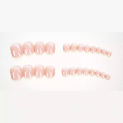 Fashion Personality toe nail stickers in skin colour with design, next to tube of adhesive glue on a flat surface.