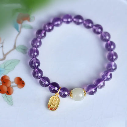 Purple amethyst crystal bead bracelet with geometric shape on an adjustable chain.