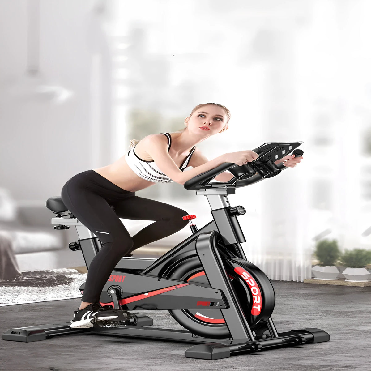 Black upright spinning bike with silent operation, infinite resistance adjustment, and display for distance, time, speed, and calories