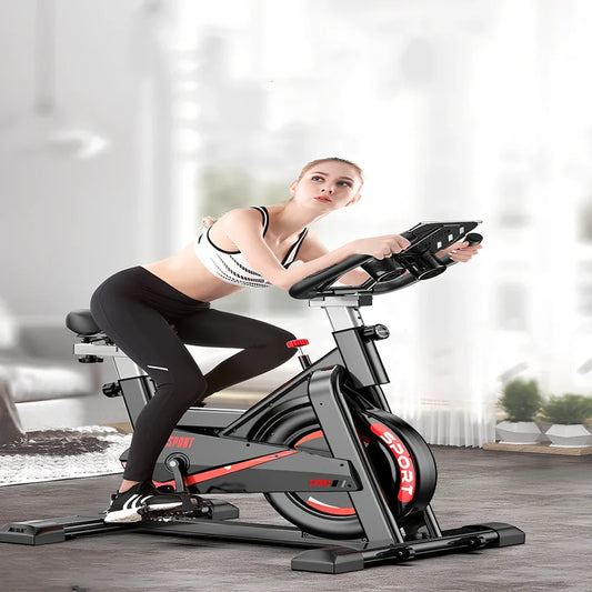 Black upright spinning bike with infinite resistance display for silent home fitness tracking distance and calories
