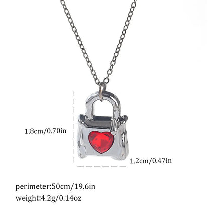 Gothic style zinc alloy necklace with bat pendant on a silver chain against dark background.