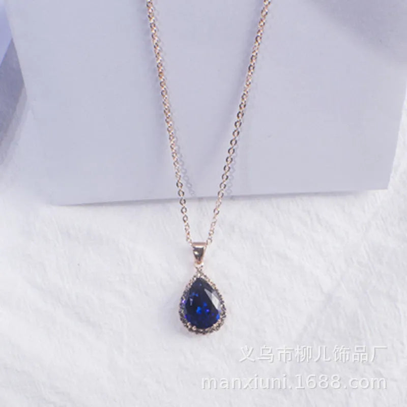 Rose gold geometric water drop pendant necklace on a model, showing adjustable chain and sparkling stone inlay.