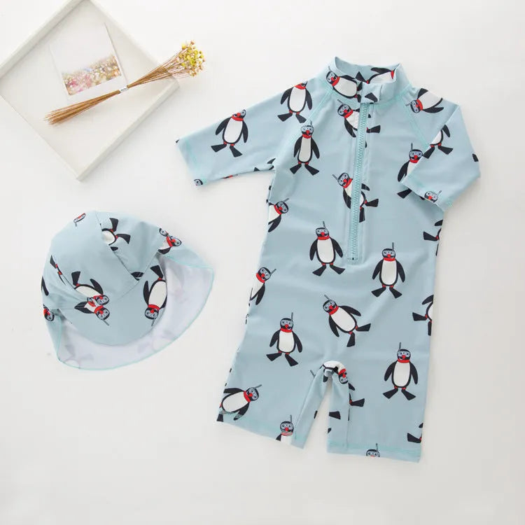 Boy's penguin print long sleeve swimsuit with matching cap for sun protection during water activities