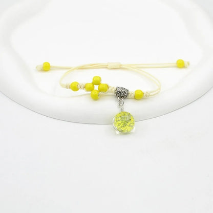 Hand-woven glass bracelet with large 1.4 cm beads containing real dried flowers, shown in blue.