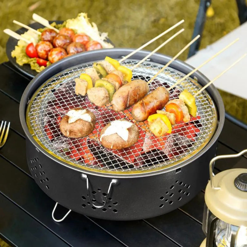 Detachable stainless steel portable barbecue grill with storage bag, shown assembled for outdoor use.
