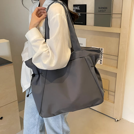 Soft Oxford cloth foldable commuter tote bag in street style, shown in multiple colour options.