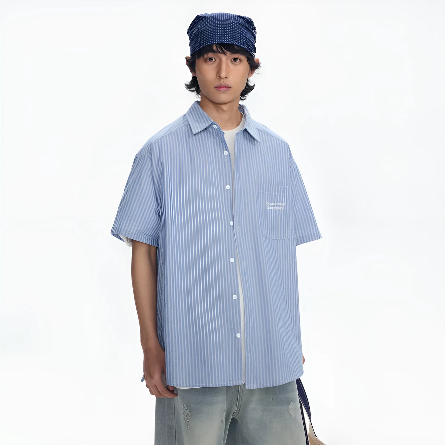 Blue and white striped loose-fitting short-sleeved overalls shirt on a hanger.