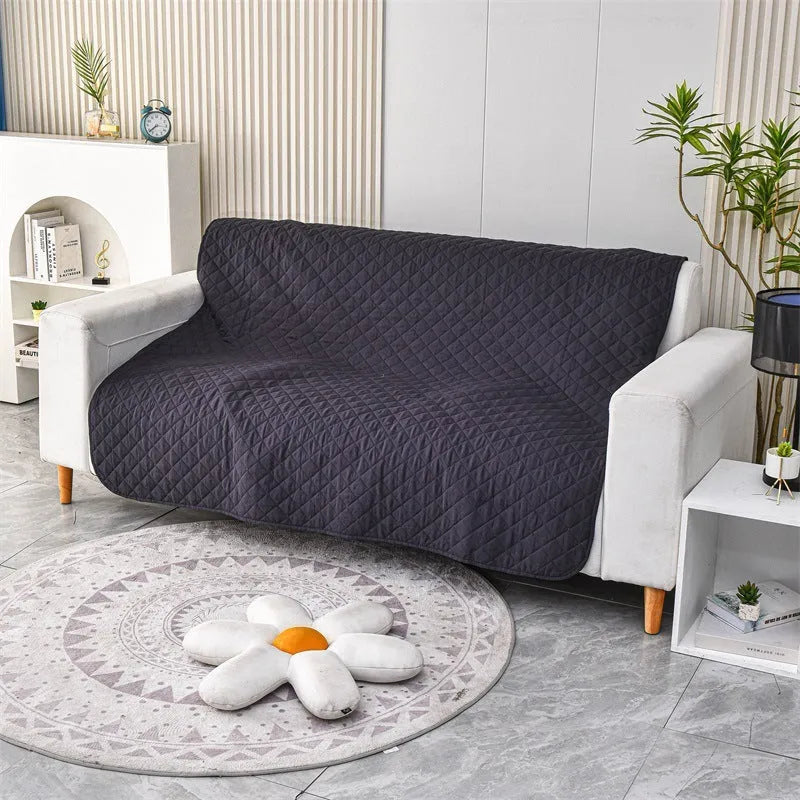 Reversible dog blanket sofa cover in burgundy and grey, laid flat on a sofa