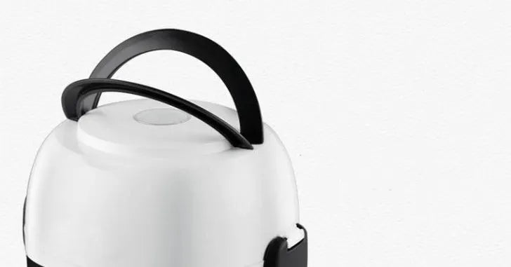 White rice cooker with stainless steel inner pot showing control panel with cook and warm settings