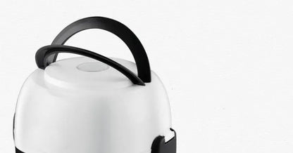 White rice cooker with stainless steel inner pot showing control panel with cook and warm settings