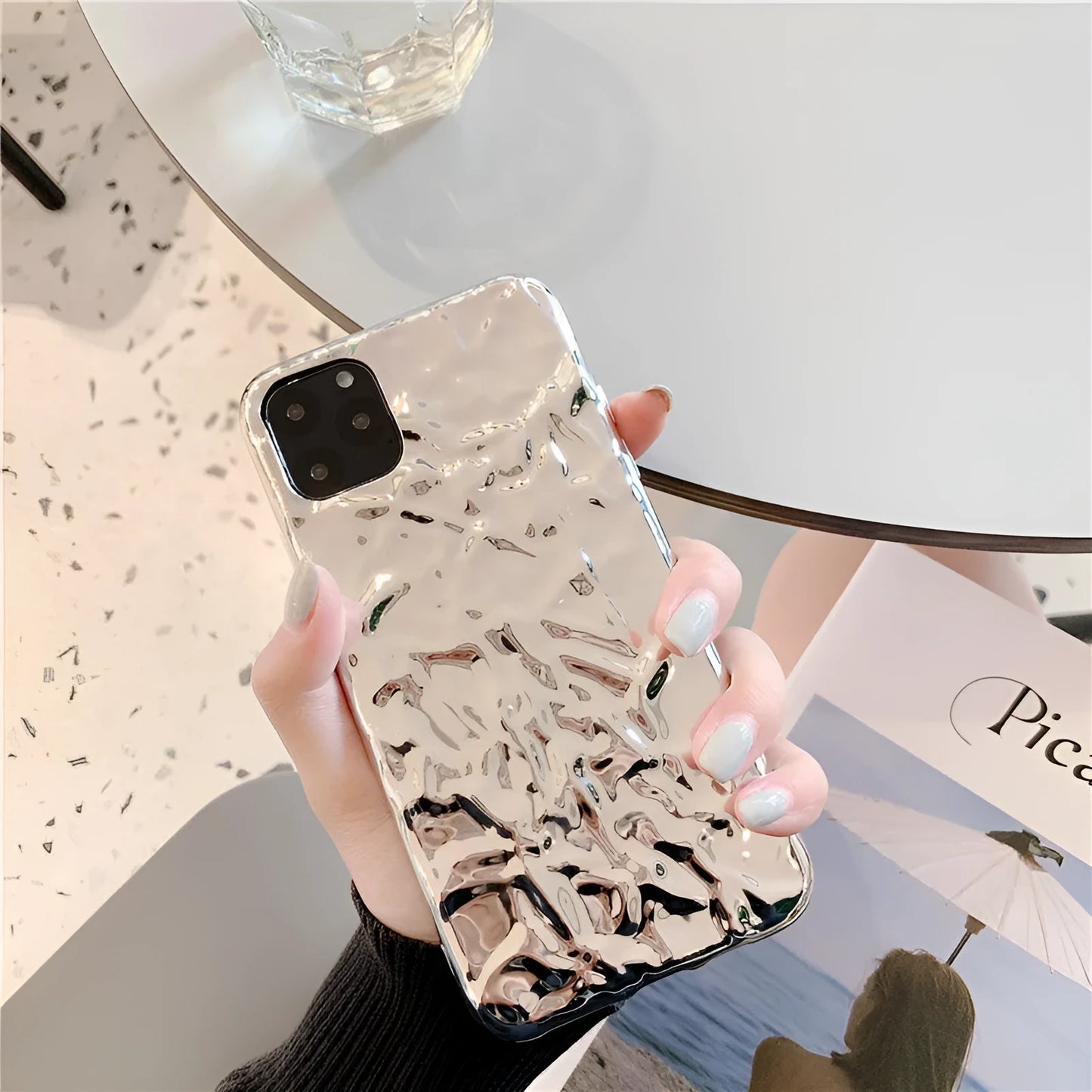Rose gold electroplated TPU back cover case for iPhone on a table.