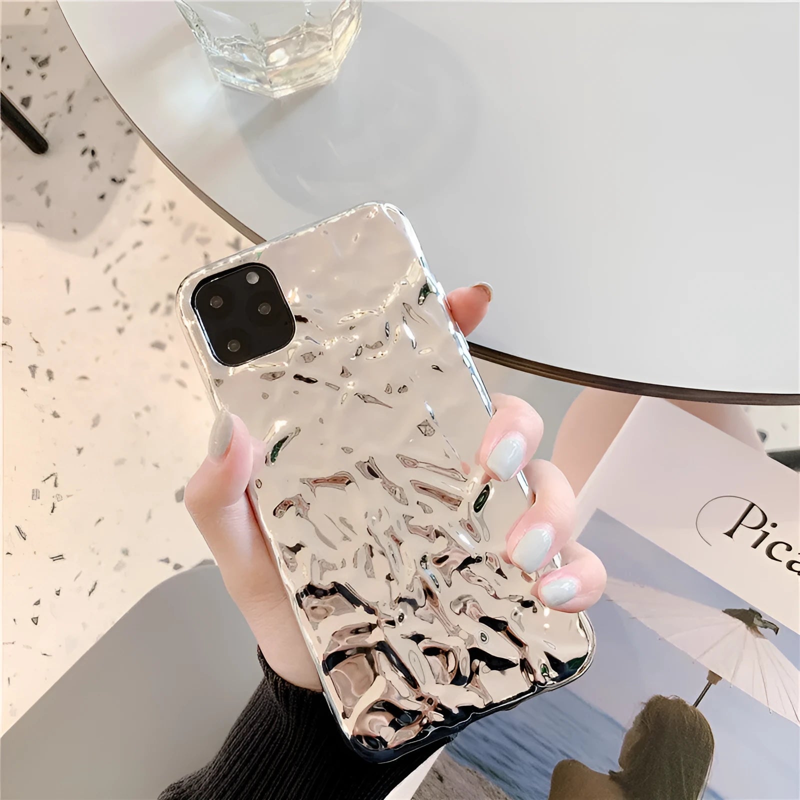 Rose gold electroplated TPU back cover case for iPhone on a table.