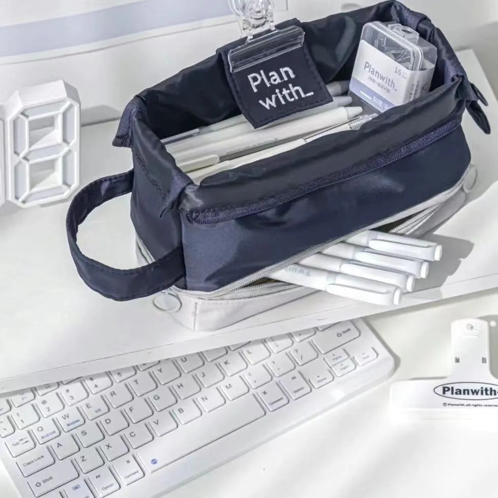 Double-layer folding pencil case showing navy blue colour with pens organised in separate compartments