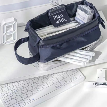 Double-layer folding pencil case showing navy blue colour with pens organised in separate compartments