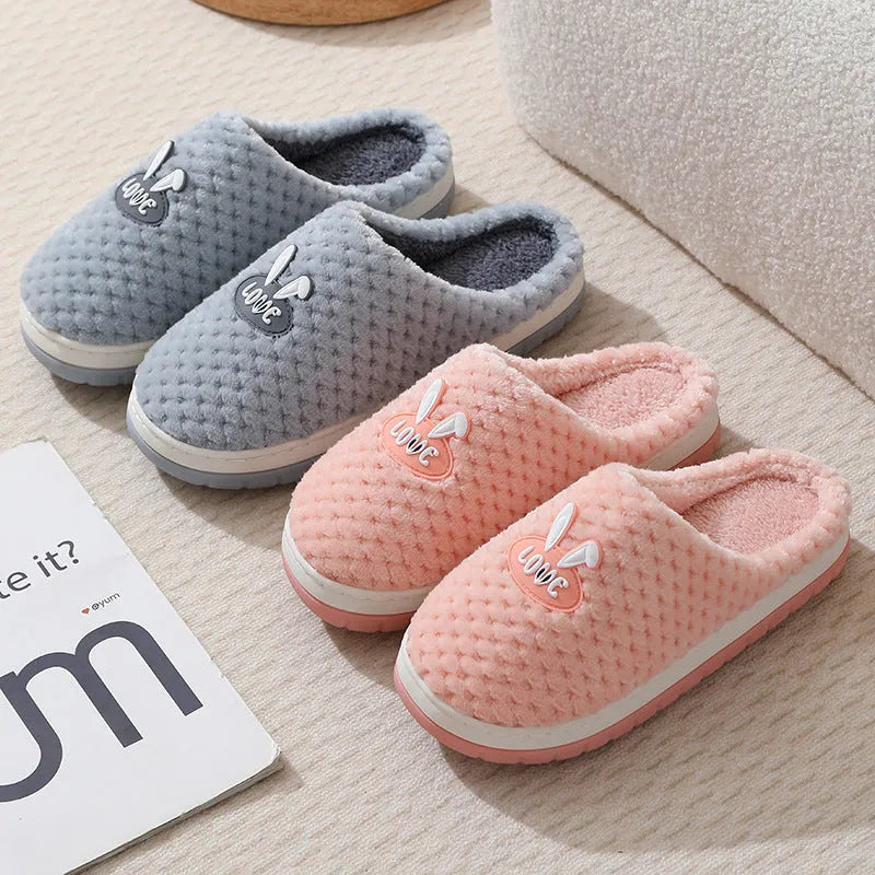 Women's plush rabbit plaid design winter slippers with a thick light-coloured rubber sole.