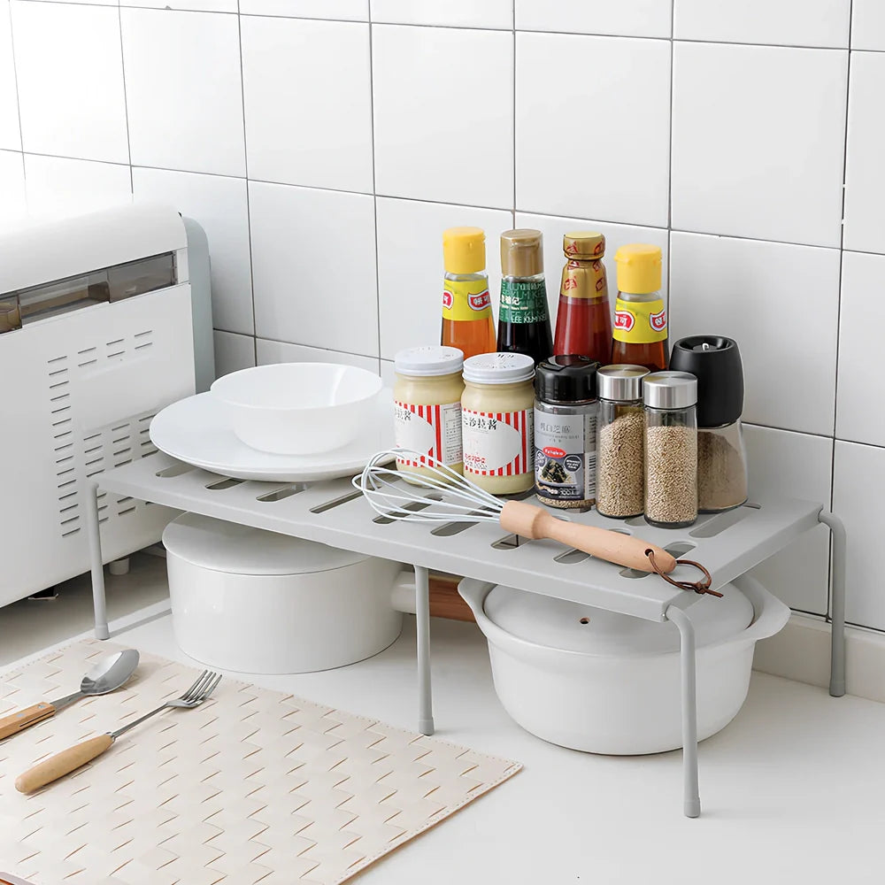 Grey retractable kitchen shelf with hollow grid design extended to 45cm width