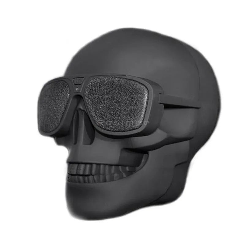 Limited edition Skull-shaped portable wireless Bluetooth speaker in various colours on a table.