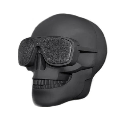 Limited edition Skull-shaped portable wireless Bluetooth speaker in various colours on a table.